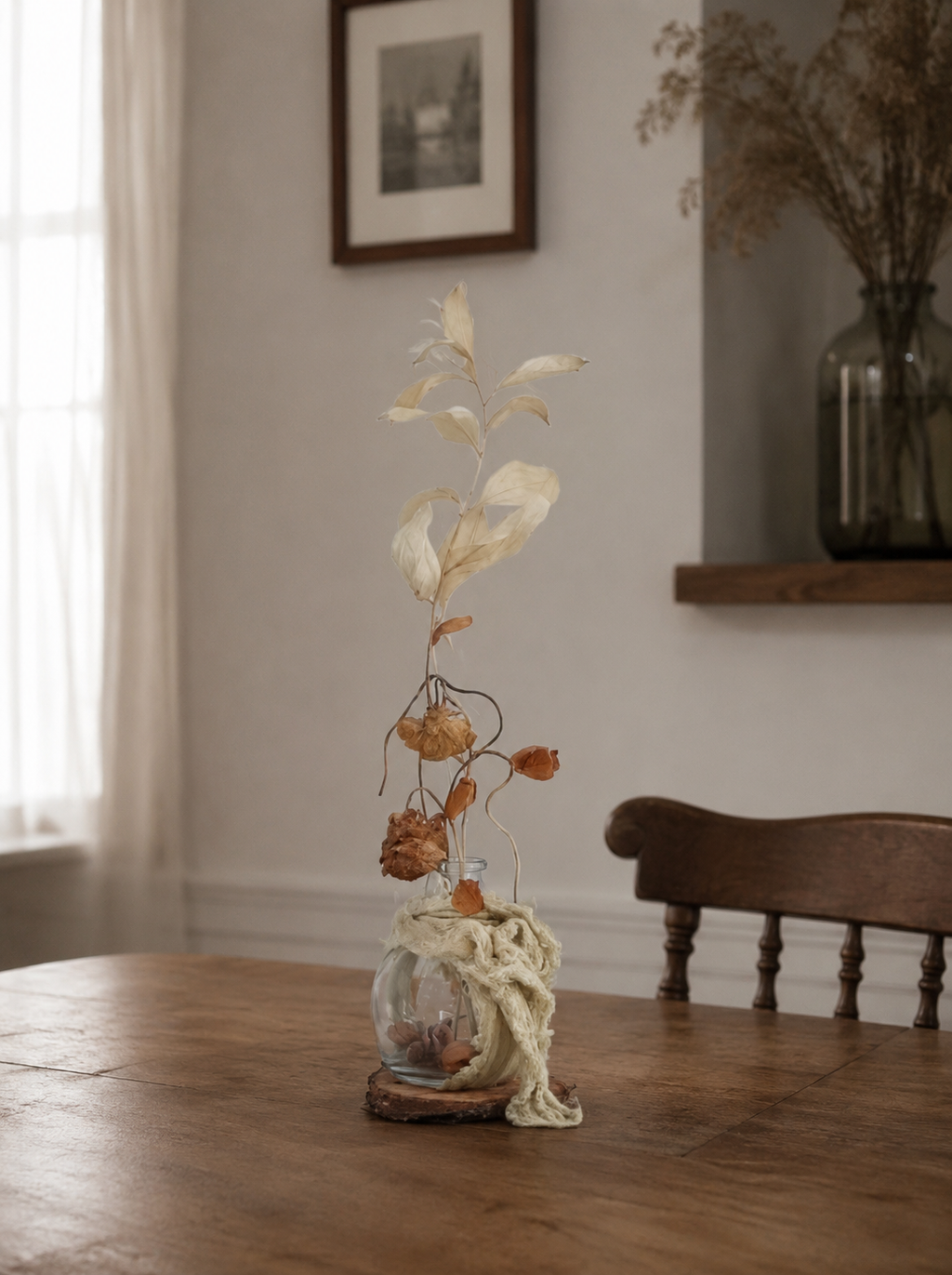 Decorative plant in a glass vase on a wooden table with a neutral background